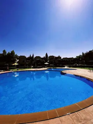 a large swimming pool with blue water at Casa Lina in Marrakech