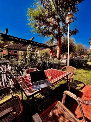 a table with a laptop on top of it at Casa Lina in Marrakech