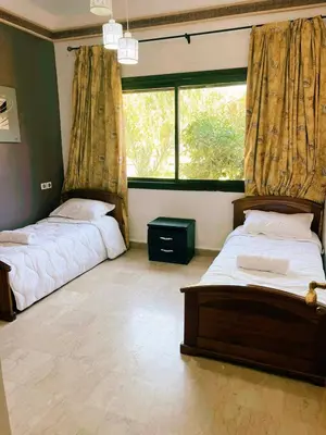 a bedroom with two beds and a large window at Casa Lina in Marrakech