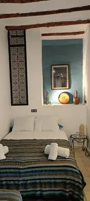 a bedroom with a large bed in a room at Riad Nafora in Marrakech