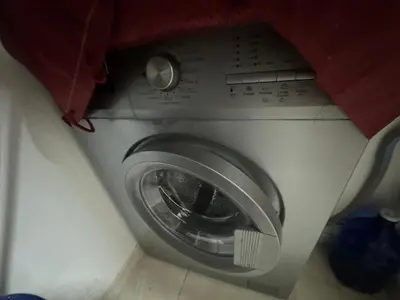 a washing machine is sitting in a room at Joli appartement nouveau Rez-de-chaussée in Marrakech