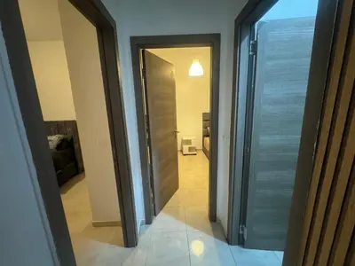 a hallway with a door leading to a room at Joli appartement nouveau Rez-de-chaussée in Marrakech