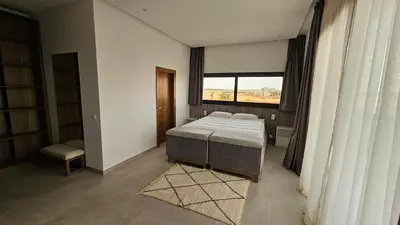 a bedroom with a bed and a large window at Villa Dar Maryam in Marrakech
