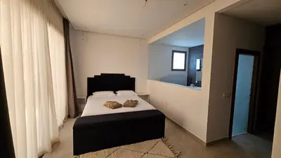 a bedroom with a bed with two shoes on it at Villa Dar Maryam in Marrakech