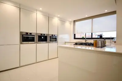 a kitchen with white cabinets and a counter top at Hevernage penthouse in Marrakech