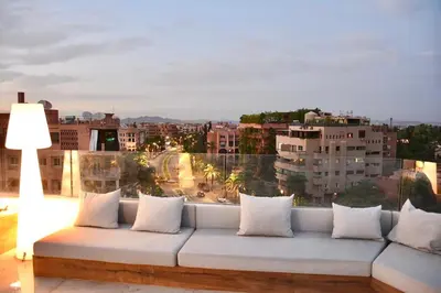 a white couch sitting on top of a building at Hevernage penthouse in Marrakech