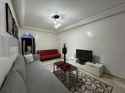 a living room with a couch and a tv at Appart de luxe a gueliz a bon prix in Marrakech
