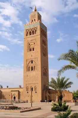 a tall building with a clock tower on top of it at Appartement impeccable en plein de centre ville in Marrakech