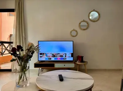 a laptop computer sitting on a table in a living room at Appartement élégant près du stade in Marrakech