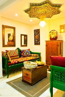 a living room with a couch and a table at The Riad Palace - Gym - Spa - Tennis Court in Marrakech