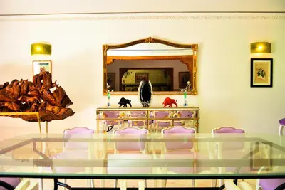 a dining room with a glass table and a mirror at The Riad Palace - Gym - Spa - Tennis Court in Marrakech