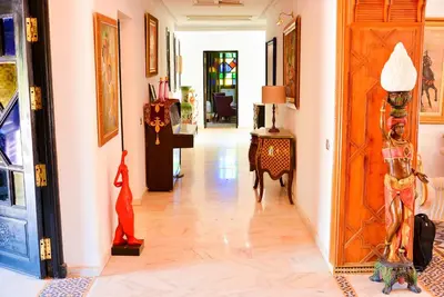 a hallway of a home with wooden floors and a door at The Riad Palace - Gym - Spa - Tennis Court in Marrakech