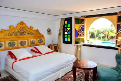 a bedroom with a bed and a window at The Riad Palace - Gym - Spa - Tennis Court in Marrakech