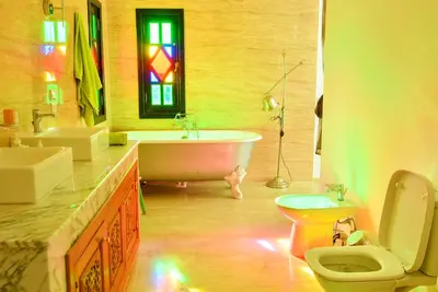 a bathroom with a tub and a toilet and a sink at The Riad Palace - Gym - Spa - Tennis Court in Marrakech