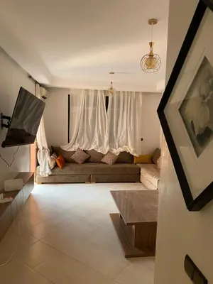 a living room with a couch in front of a window at Séjour Étoilé in Marrakech