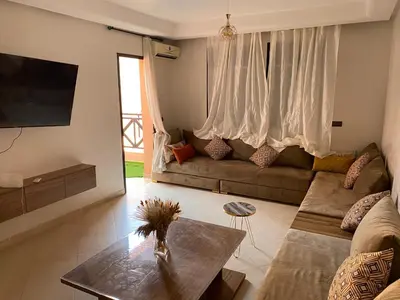 a living room with a couch and a table at Séjour Étoilé in Marrakech