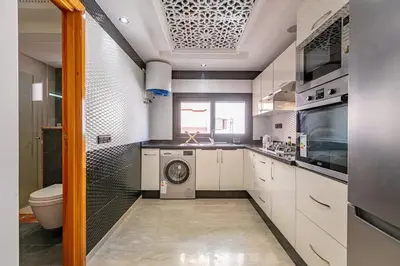 a kitchen with a washing machine and a sink at Modern New Appartement Fully Equiped In Center of guéliz in Marrakech