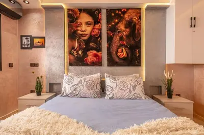 a bedroom with a large painting above a bed at Modern New Appartement Fully Equiped In Center of guéliz in Marrakech