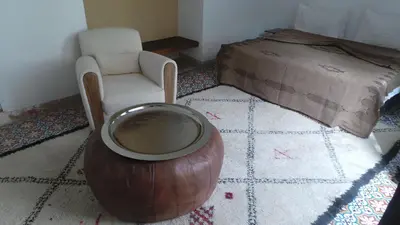 a room with a bowl and a chair and a bed at Riad Maialou & SPA in Marrakech