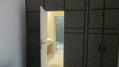 a bathroom with a door open to a bathroom with a toilet at Riad Maialou & SPA in Marrakech