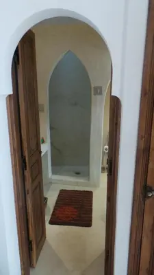 a hallway with an archway in a room with a rug at Riad Maialou & SPA in Marrakech