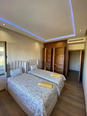 a bedroom with a bed with two pillows on it at villa de luxe avec piscine privée in Marrakech