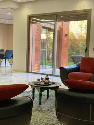 a living room with two couches and a coffee table at villa de luxe avec piscine privée in Marrakech