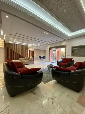 a large living room with two couches and a table at villa de luxe avec piscine privée in Marrakech