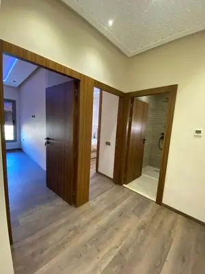 an empty room with doors and wood floors at villa de luxe avec piscine privée in Marrakech