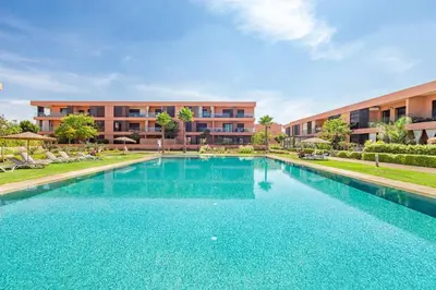 a large swimming pool in front of a building at New! Appt Charme, Elégance à NORIA GOLF in Marrakech