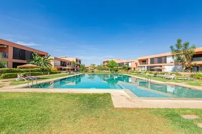 a large swimming pool in front of a building at New! Appt Charme, Elégance à NORIA GOLF in Marrakech