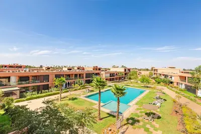 an aerial view of a resort with a swimming pool and palm trees at New! Appt Charme, Elégance à NORIA GOLF in Marrakech
