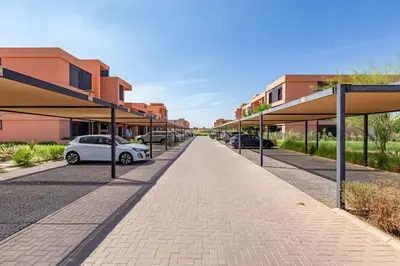 a street with cars parked in front of buildings at New! Appt Charme, Elégance à NORIA GOLF in Marrakech