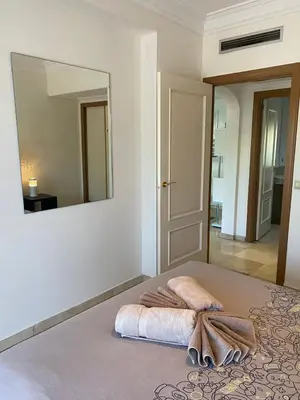 a bedroom with a bed with a large mirror at Appartement cosy à deux pas du Jardin Majorelle in Marrakech
