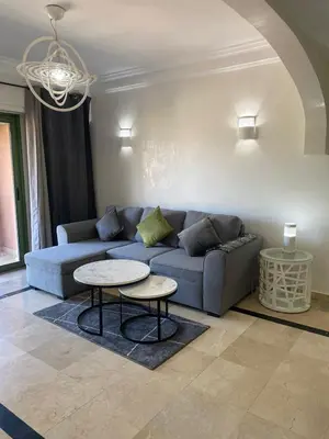 a living room with a couch and a table at Appartement cosy à deux pas du Jardin Majorelle in Marrakech