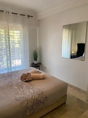 a bedroom with a large bed with a large mirror at Appartement cosy à deux pas du Jardin Majorelle in Marrakech