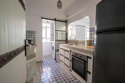 a kitchen with a sink and a counter top at Élégant appartement avec terrasse au cœur Guéliz in Marrakech