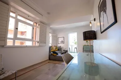 a living room with a glass table and a couch at Élégant appartement avec terrasse au cœur Guéliz in Marrakech