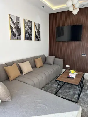 a living room with a couch and a flat screen tv at JASMINe in Marrakech
