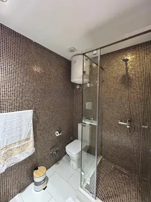 a bathroom with a toilet and a glass shower at JASMINe in Marrakech