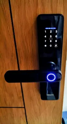 a remote control sticking out of a wooden door at JASMINe in Marrakech