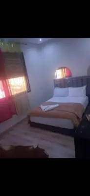 a bedroom with a bed with a lamp on it at Hostel GSK in Marrakech
