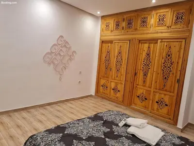 a bedroom with wooden cabinets and a bed in a room at Hostel GSK in Marrakech