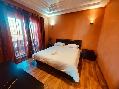 a bedroom with a bed with two stuffed animals on it at Naoura House in Marrakech