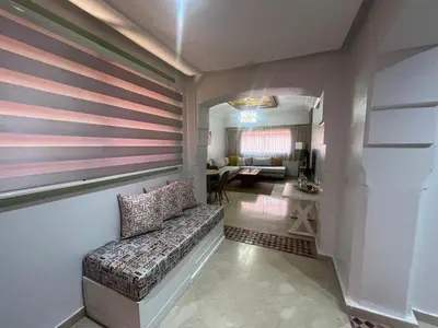 a room with a couch and a living room at Bel Appartement meublé avec Piscine, l'hivernage à Marrakech in Marrakech