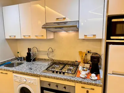 a kitchen with a stove top oven next to a sink at Pearl Garden Studio Cosy Lux Elegant Sunny Terrace Piscine in Marrakech
