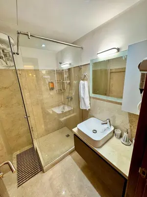 a bathroom with a shower and a sink and a toilet at Pearl Garden Studio Cosy Lux Elegant Sunny Terrace Piscine in Marrakech