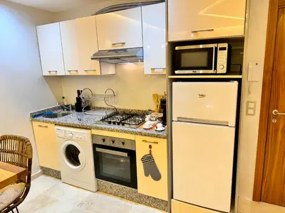 a kitchen with a refrigerator and a microwave at Pearl Garden Studio Cosy Lux Elegant Sunny Terrace Piscine in Marrakech