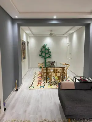 a living room with a dining room table and a table and a dining room at Luxury Apartment in City Center of Marrakech in Marrakech