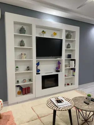 a living room with a tv on a wall at Luxury Apartment in City Center of Marrakech in Marrakech